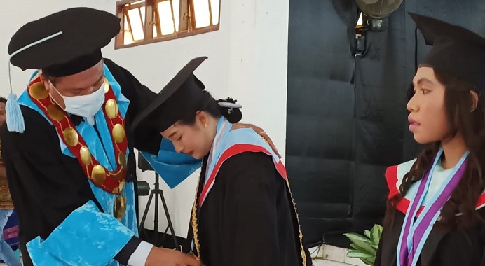 Rektor Untrib Alfonso F. Gorang, S.Sos.,MM, memberikan penghargaan kepada lulusan terbaik atas nama Noni Adewulan Astuti Morib, S.Pd., pada acara Wisuda Untrib, Selasa (30/11/2021) di Aula Pola, Kalabahi.